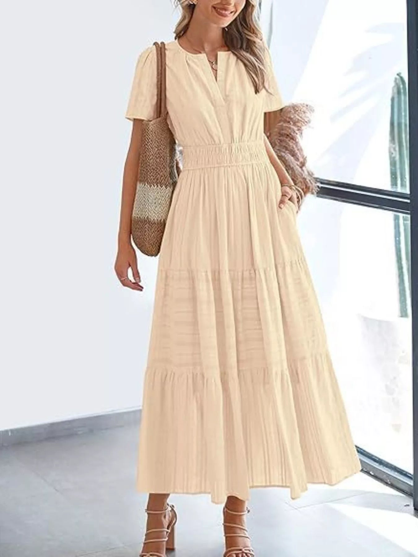 Tiered midi dress in cream, short sleeves, V-neck, smocked waist, tiered midi skirt.
