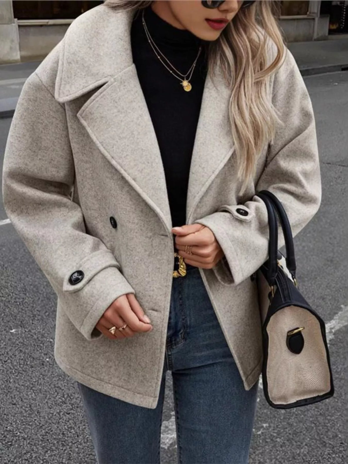 Women’s light gray double-breasted jacket with notched lapels and button cuffs