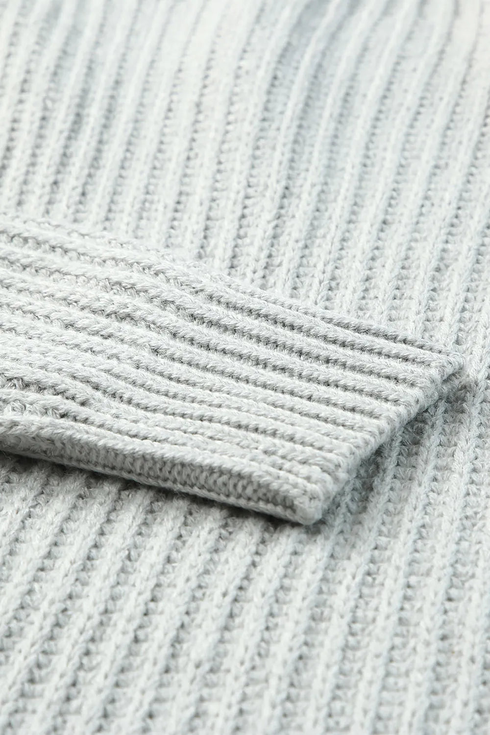 Gray ribbed knit sweater sleeve cuff and hem close-up
