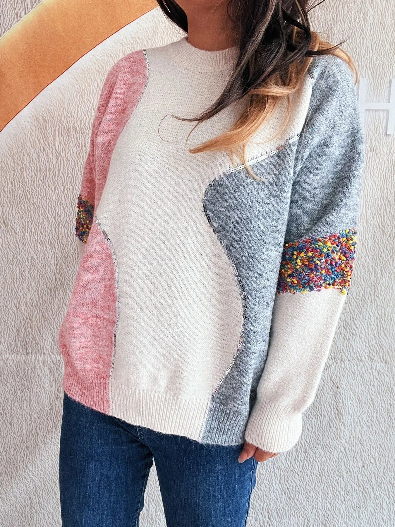 Dropped shoulder sweater with white base, pink and blue color blocks, multicolor sleeve cuffs