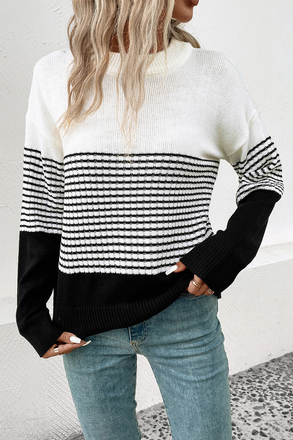 Striped drop-shoulder sweater in white with black horizontal stripe panel, ribbed hem and cuffs