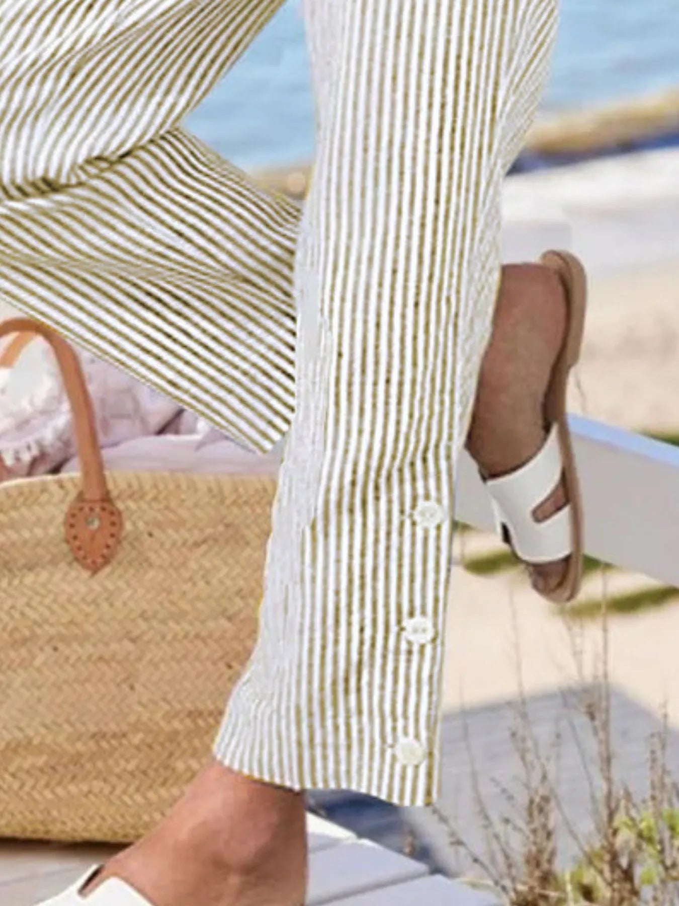 Plus size striped side-button detail pants close-up in light yellow and white