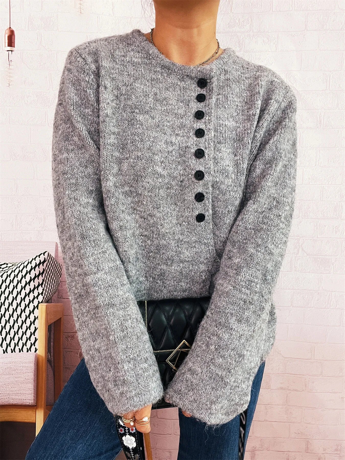 Gray knit button-front side-tie sweater with long sleeves and center black button row