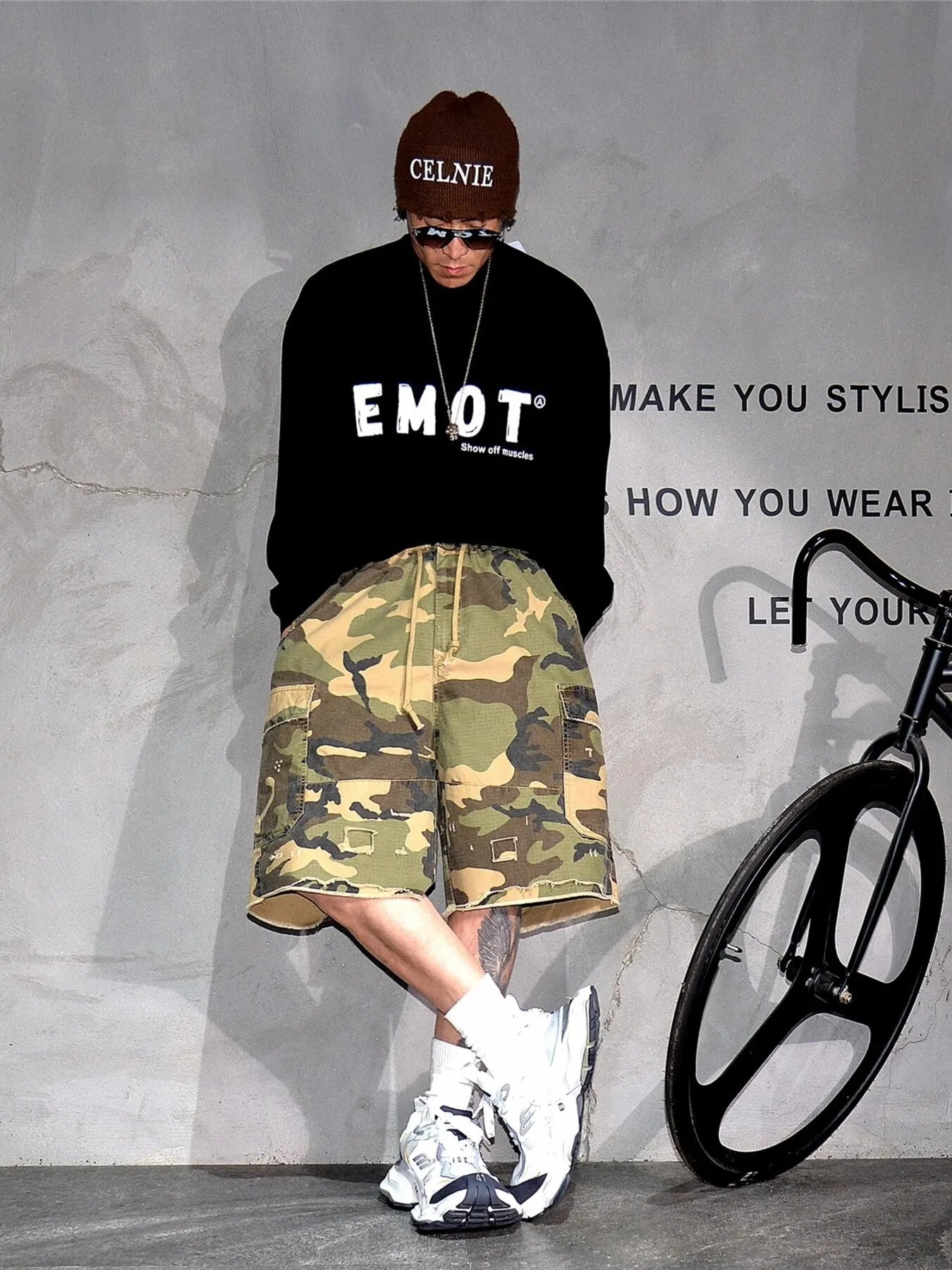 Light green camouflage cargo shorts with button-front closure and patch cargo pockets