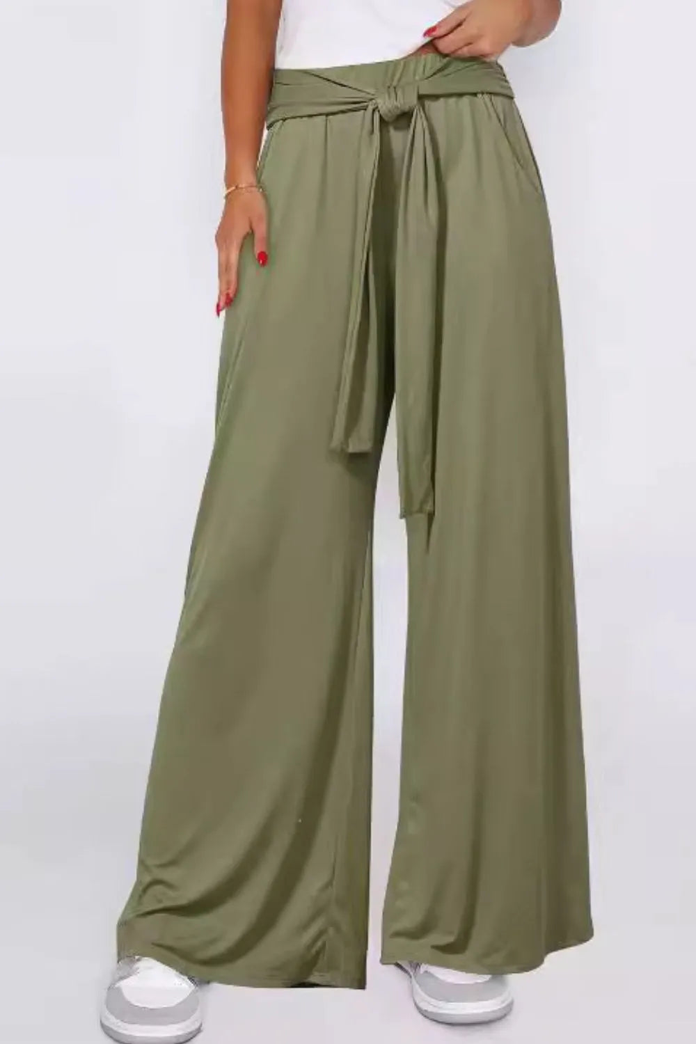 Moss green wide-leg pants with tied waist and side pockets, draped fabric with gathers.