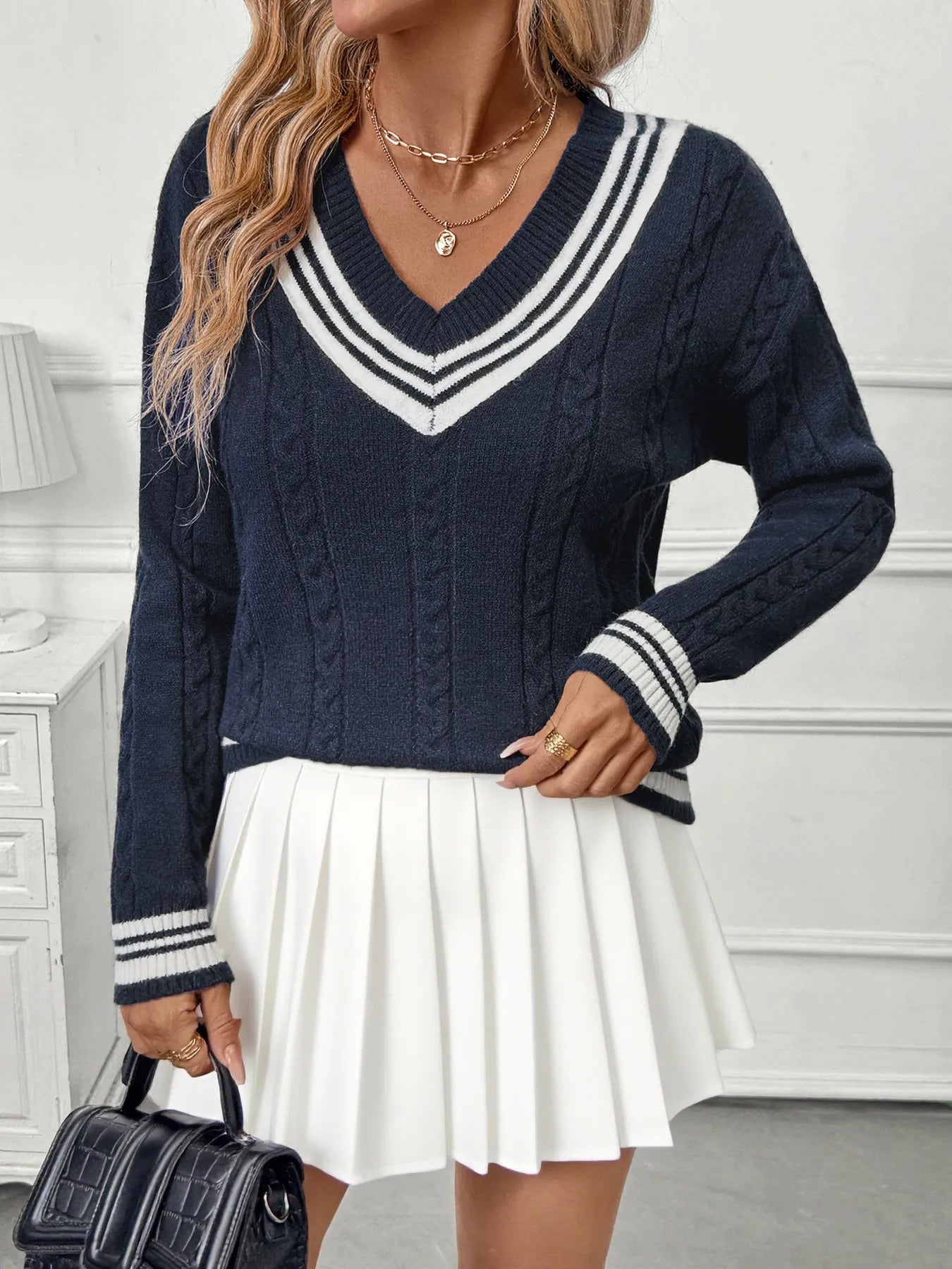 Dark blue V-neck sweater with contrast stripe cuffs and hem band