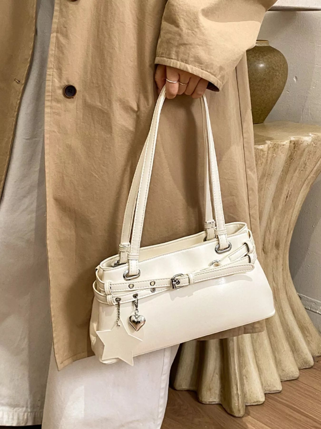 White vegan leather shoulder bag with star buckle detail and top handles