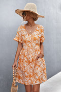 Orange floral printed button-front dress with V-neck, short sleeves, and patch pockets.