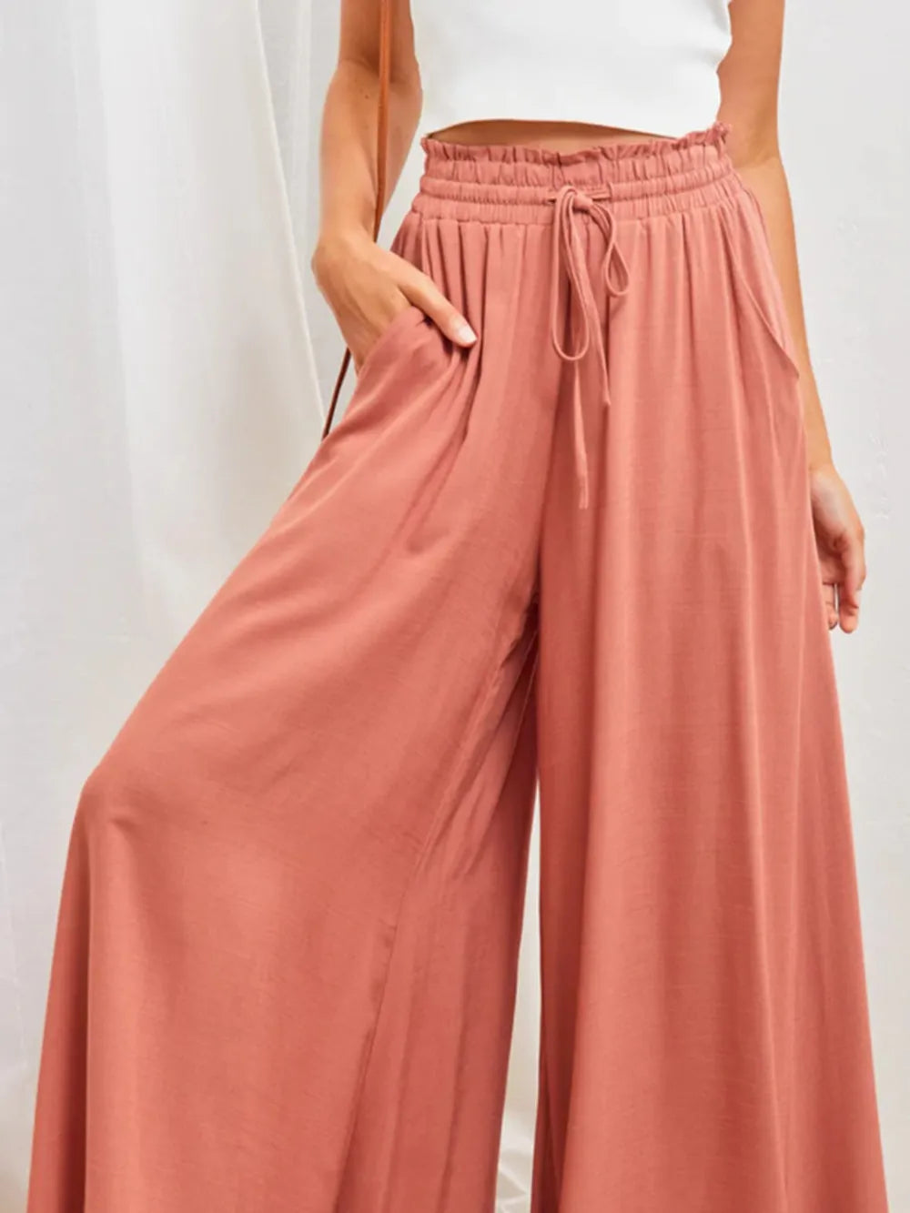 High-waist wide-leg pants in coral with elastic drawstring waist and roomy wide-leg fit