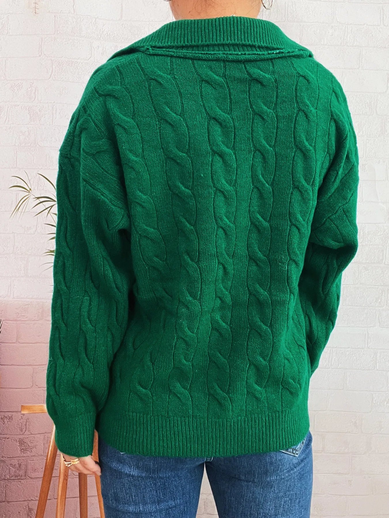 Green cable-knit Johnny collar sweater with textured cable pattern and ribbed hem