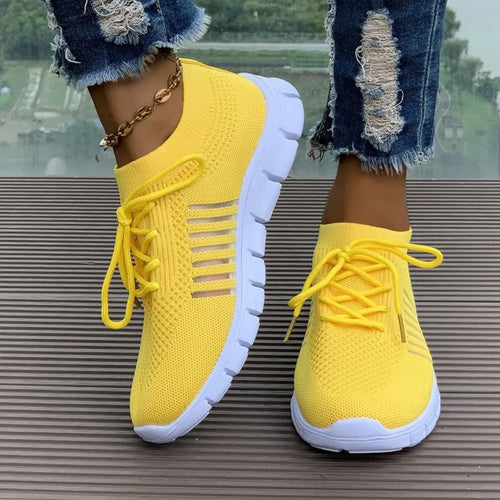Yellow breathable mesh athletic shoes, round toe, lace-up, striped sides, white sole.
