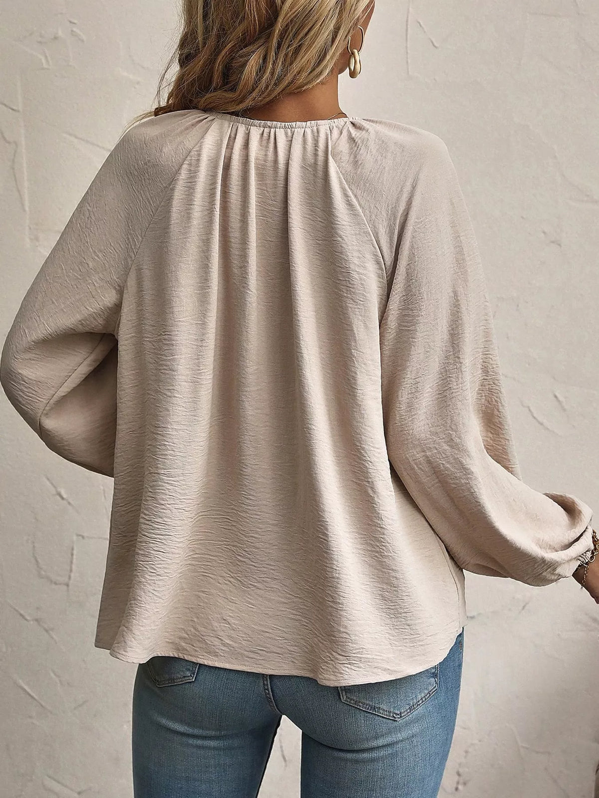Apricot blouse back view with gathered long sleeves and rounded yoke