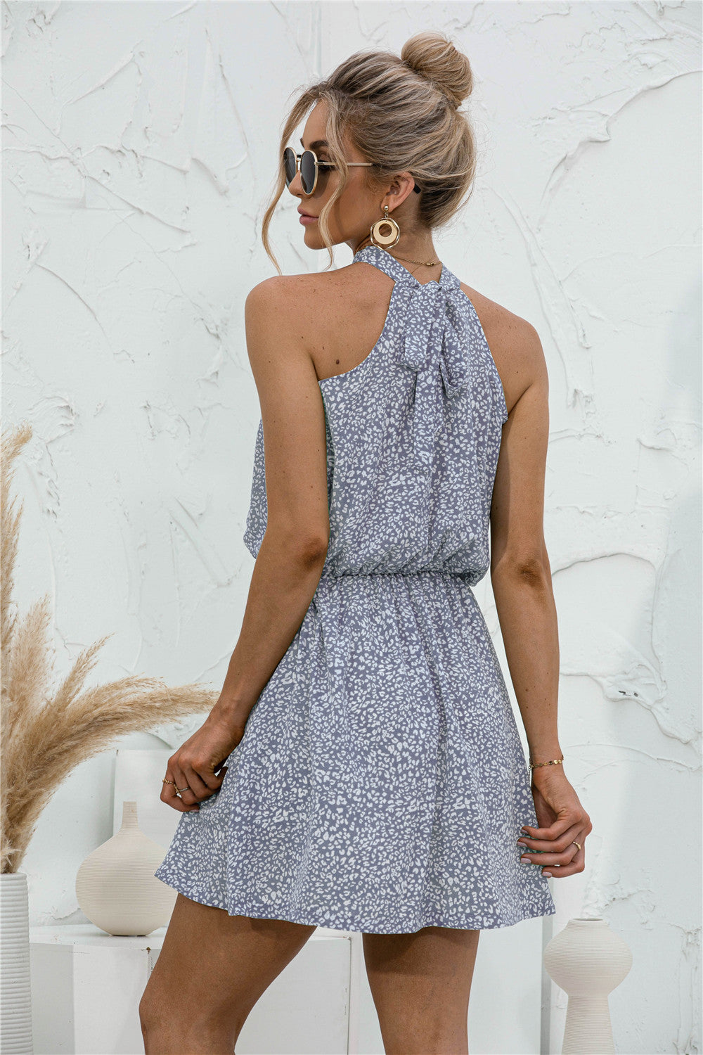 Floral tied sleeveless mini dress in light blue with halter neckline and gathered waist