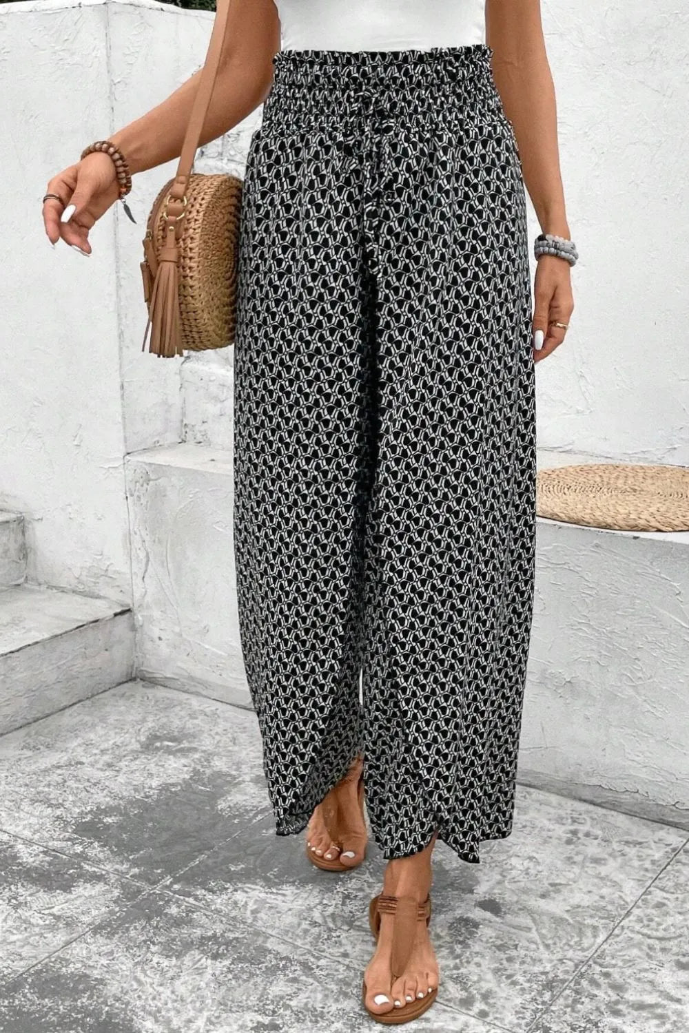 Black patterned wide-leg pants with elastic waist and side slit, relaxed fit