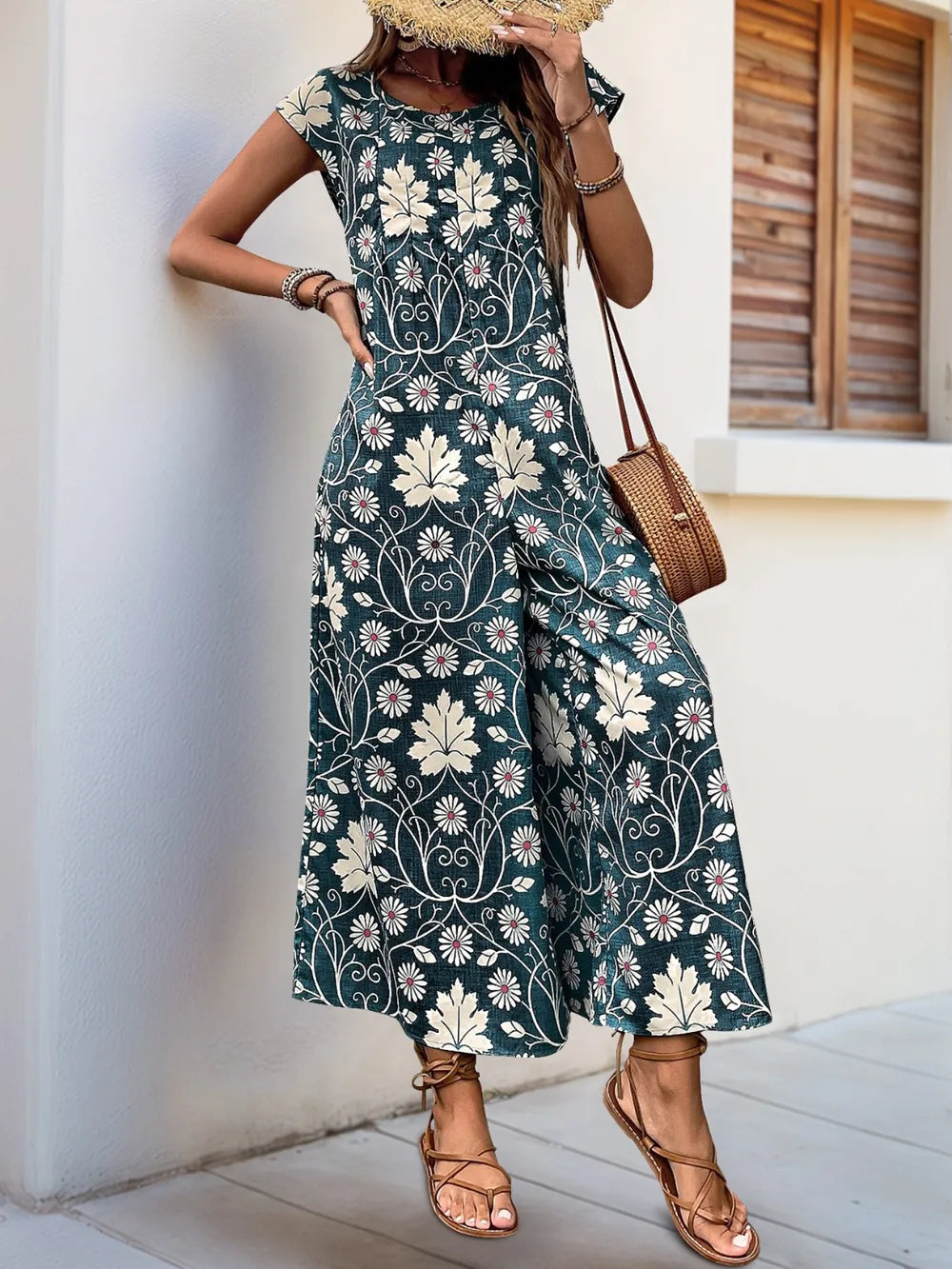 Dark teal printed wide-leg jumpsuit with round neckline and cap sleeves