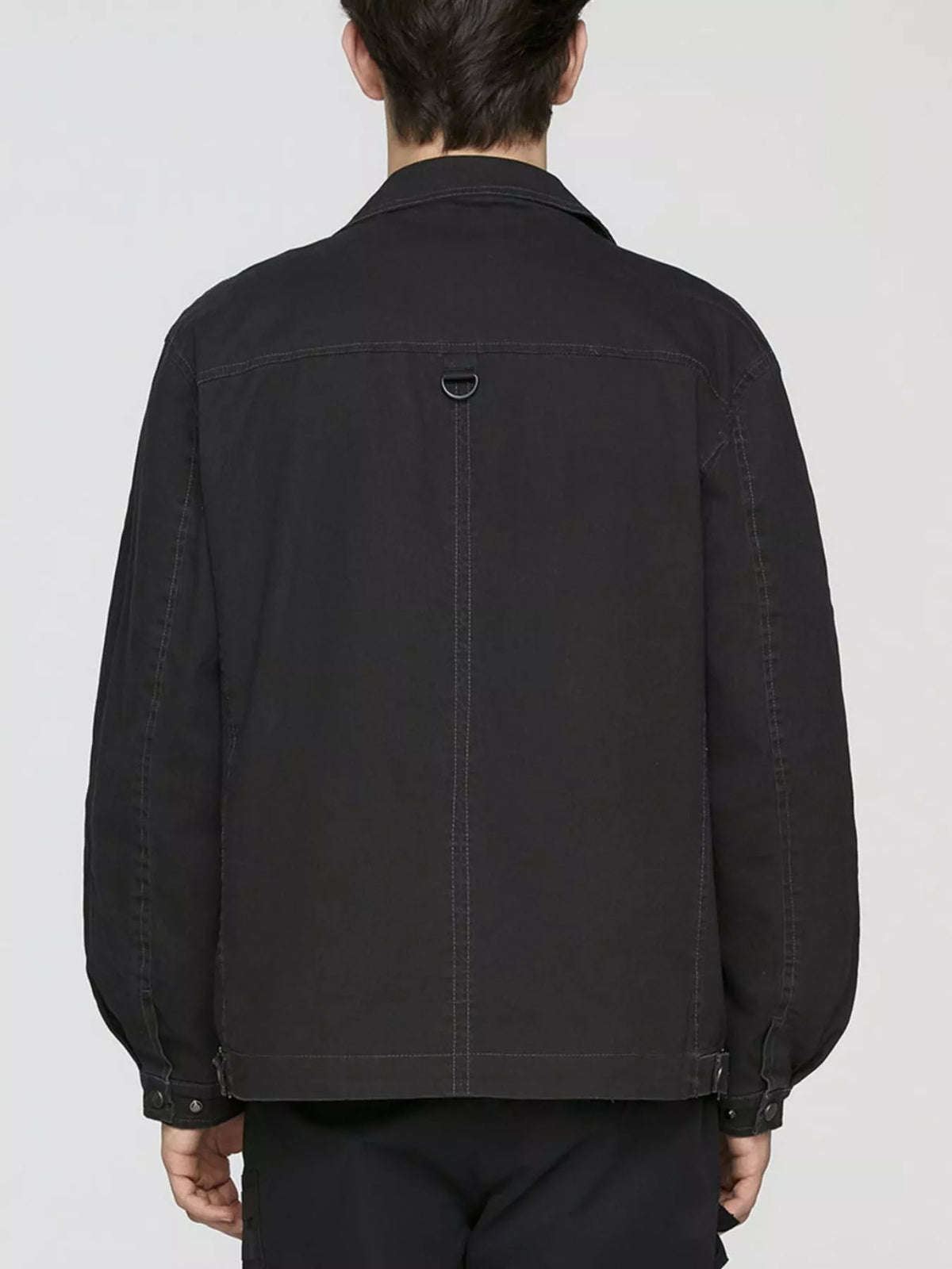 Men's black cotton button-up jacket, back view with yoke seam and buttoned cuffs