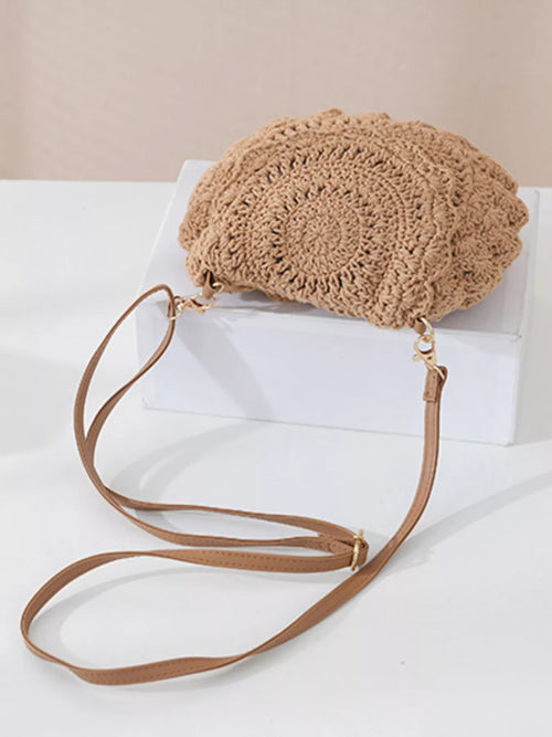 Khaki crochet crossbody bag with long braided strap and gold-tone hardware.