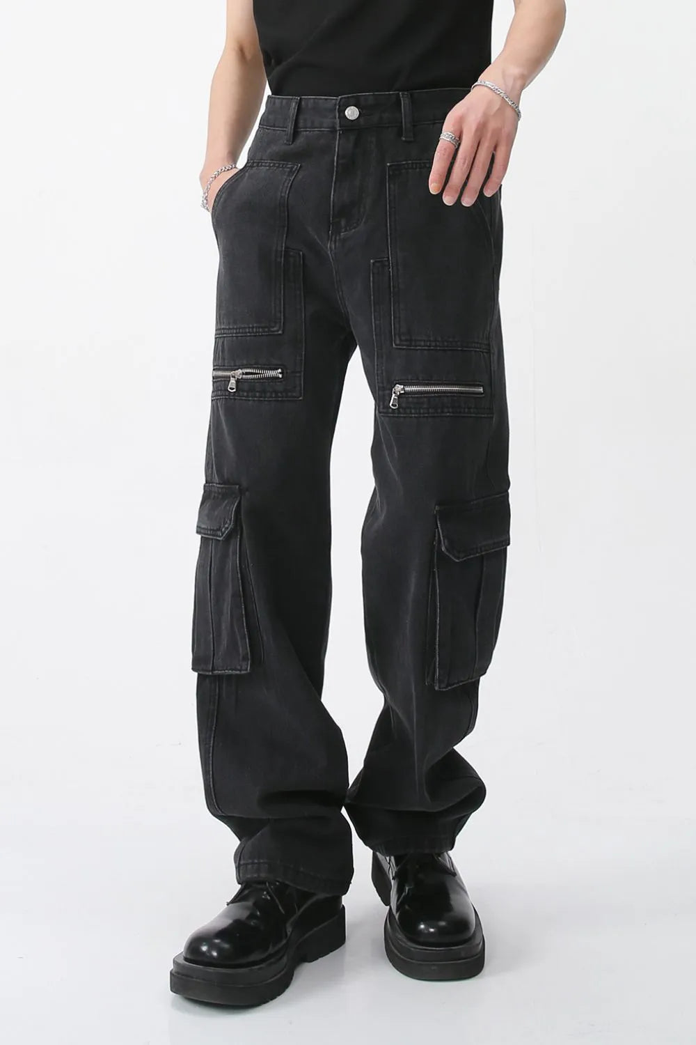 Dark loose-fit jeans with front cargo pockets and zipper details