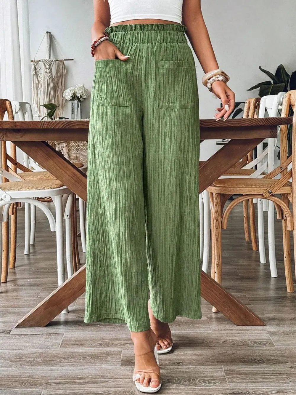 Green pocketed wide-leg pants with elastic waistband and textured fabric