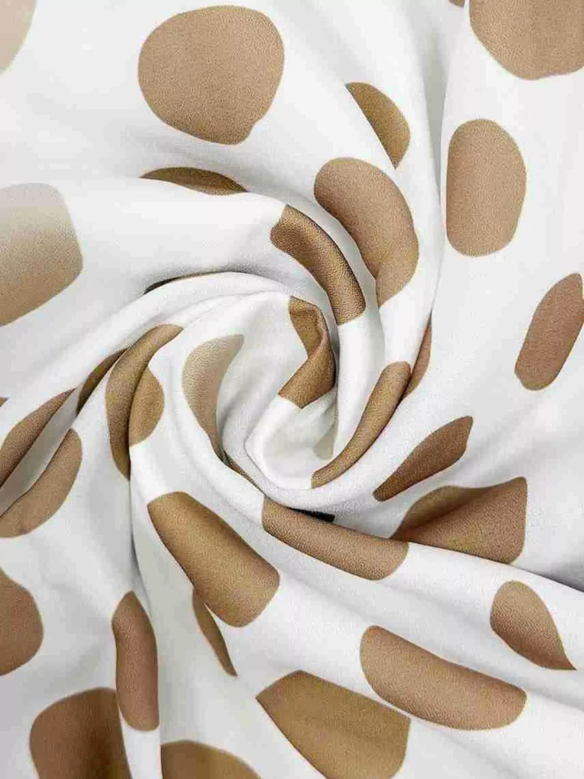 White fabric with beige polka dots, draped for texture