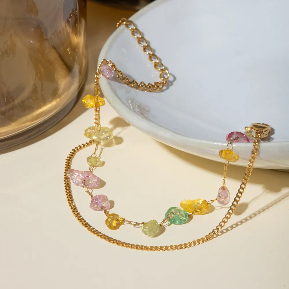 Gold bracelet with dangling multicolor stone charms and adjustable chain