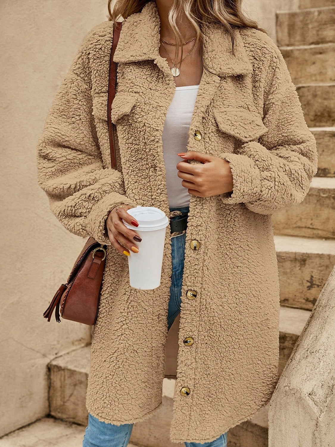 Tan collared button-down sherpa coat with flap pockets and visible button placket