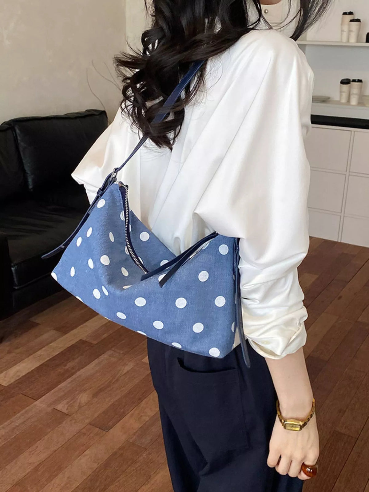 Small blue polka dot shoulder bag with zipper top and adjustable long strap