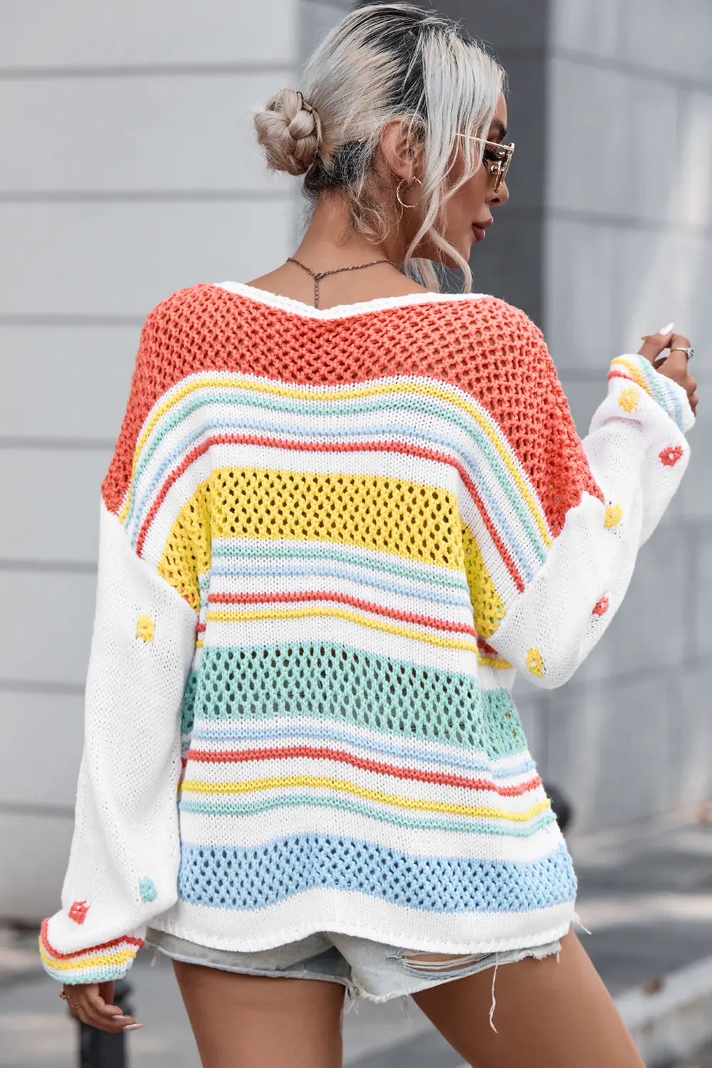 Openwork striped sweater, back view; orange yoke with rainbow horizontal stripes, long sleeves