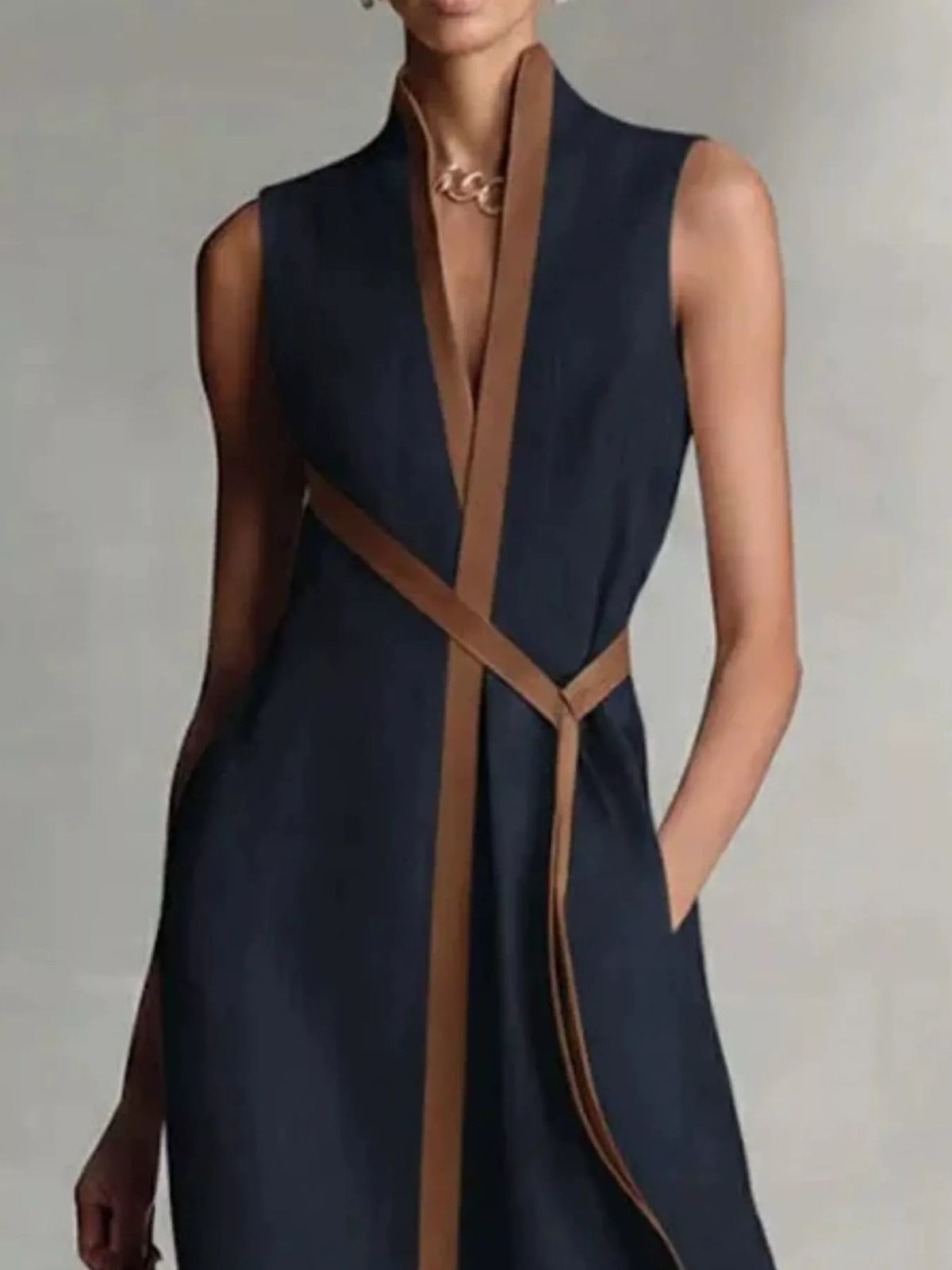 Dark blue wrap maxi dress with contrast trim, sleeveless V-neck and tied waist belt