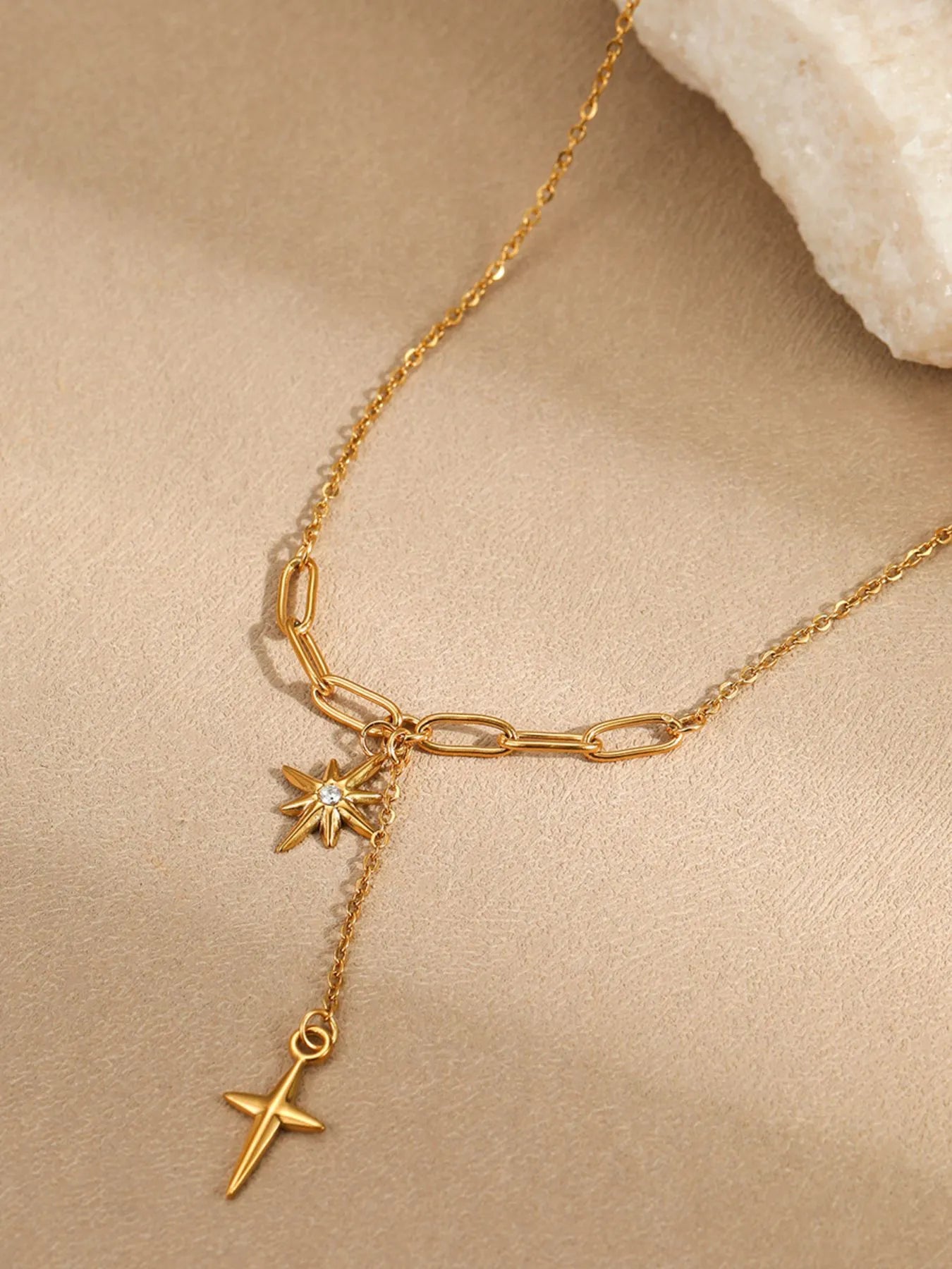 Gold-plated pendant necklace with linked chain and star-and-cross pendants