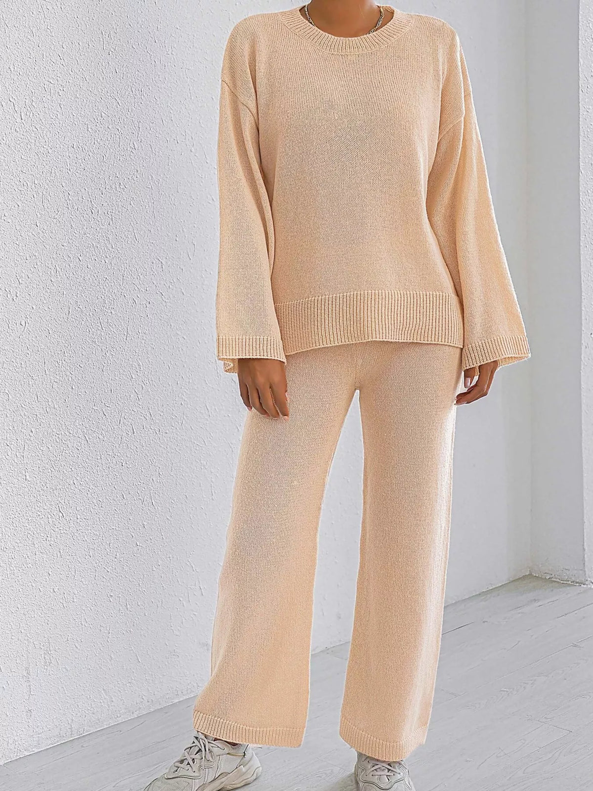 Apricot knit sweater and pants set with dropped shoulders and ribbed cuffs, wide-leg pants.
