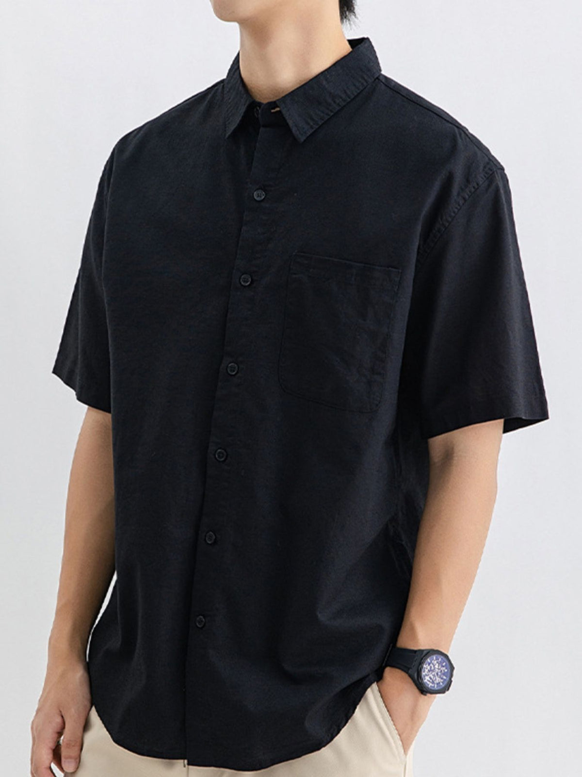Men's relaxed-fit short sleeve button-up shirt in black, chest pocket and button front