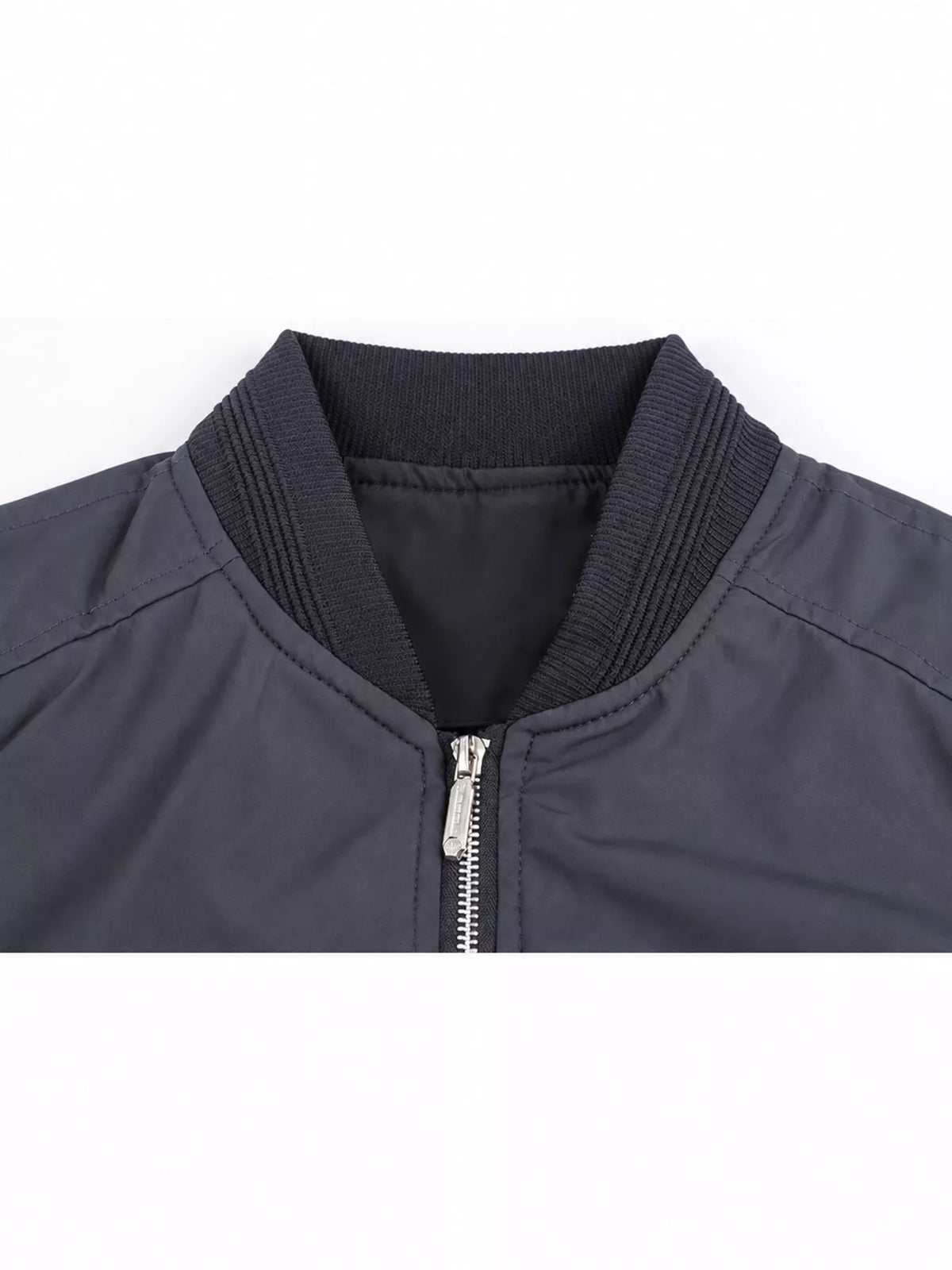 Lightweight men’s bomber jacket in dark blue, close-up of zip front and ribbed collar