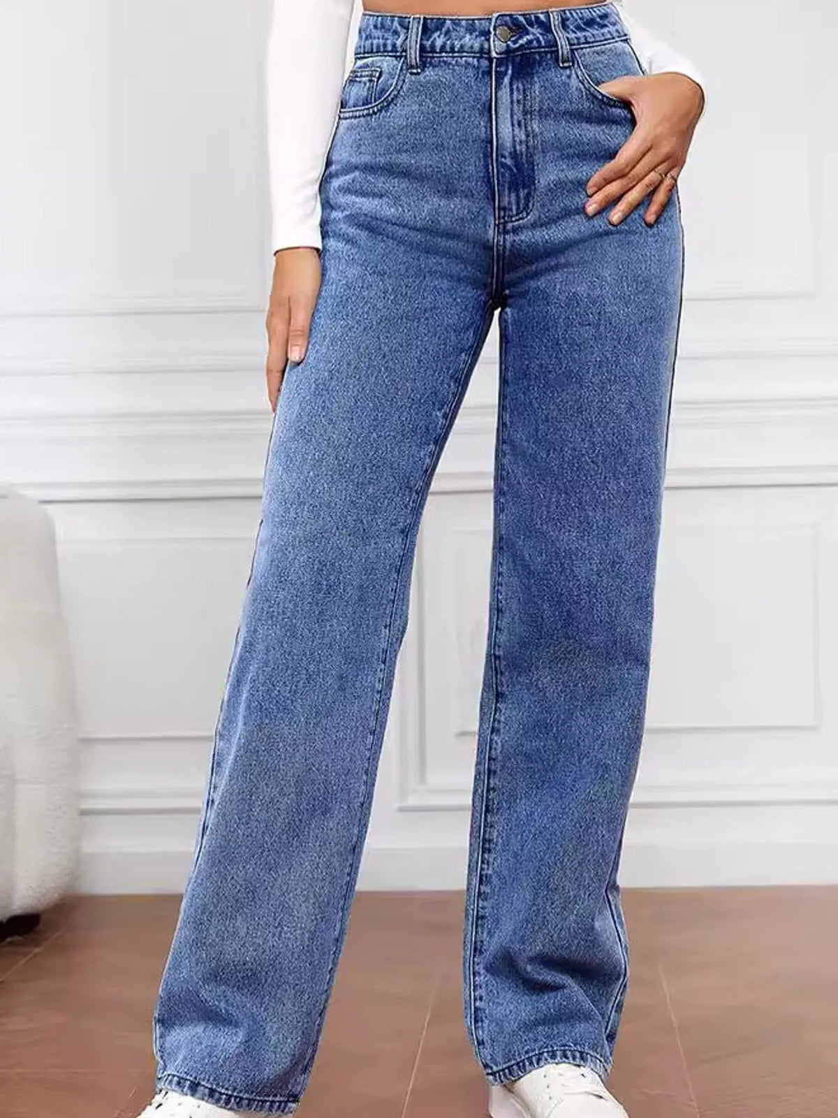 High-waisted vintage wash denim jeans with straight wide leg and front button closure