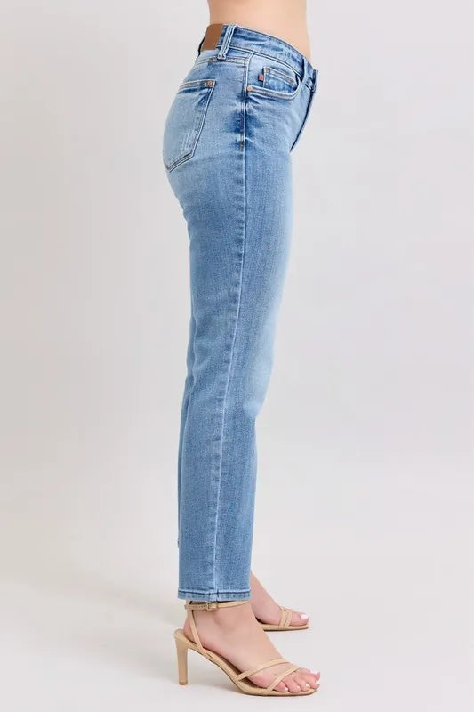 Light blue mid-rise slim jeans shown from the side with cuffed ankle hem and back pockets