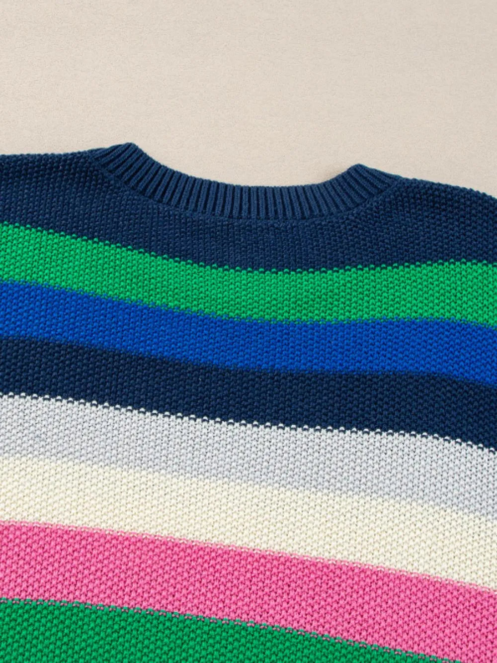 Close-up of horizontal stripes on round-neck sweater in navy, green, blue, white, pink