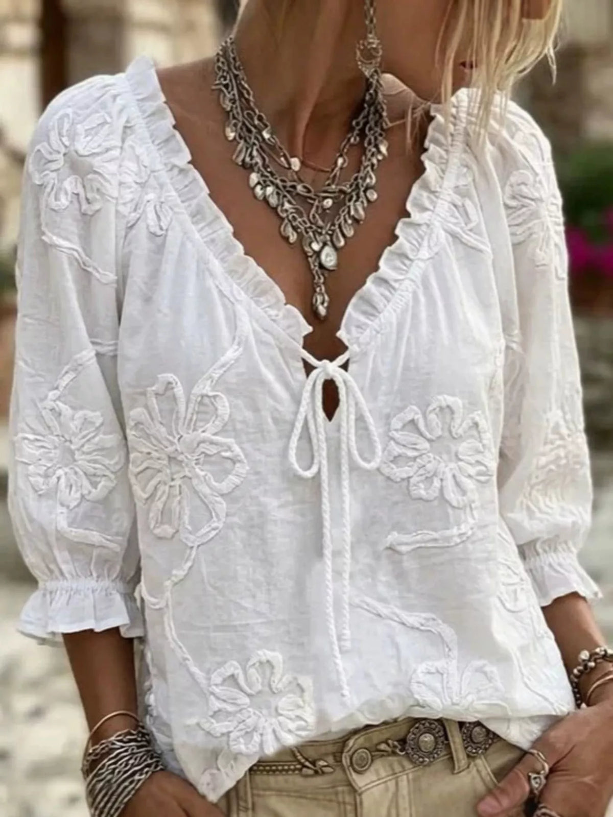 White floral embroidered tie-neck ruffled blouse with long puff sleeves