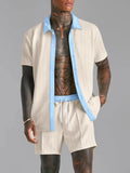 Tan two-piece set: short-sleeve collared shirt and matching shorts with blue trim
