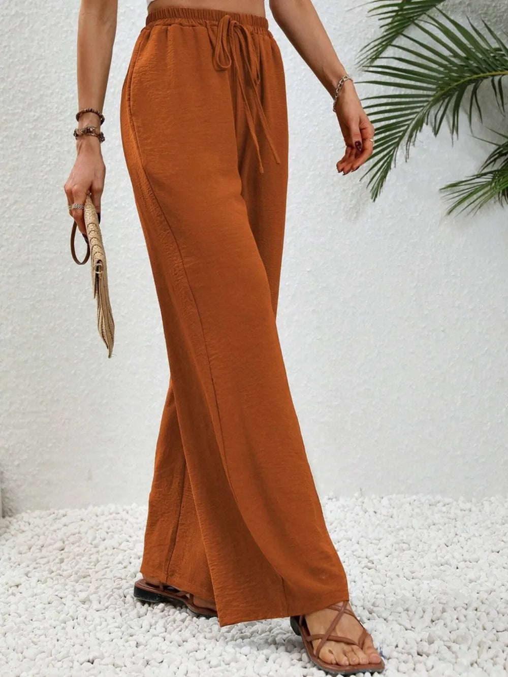 Caramel wide-leg drawstring pants with elastic waist and long flared hem