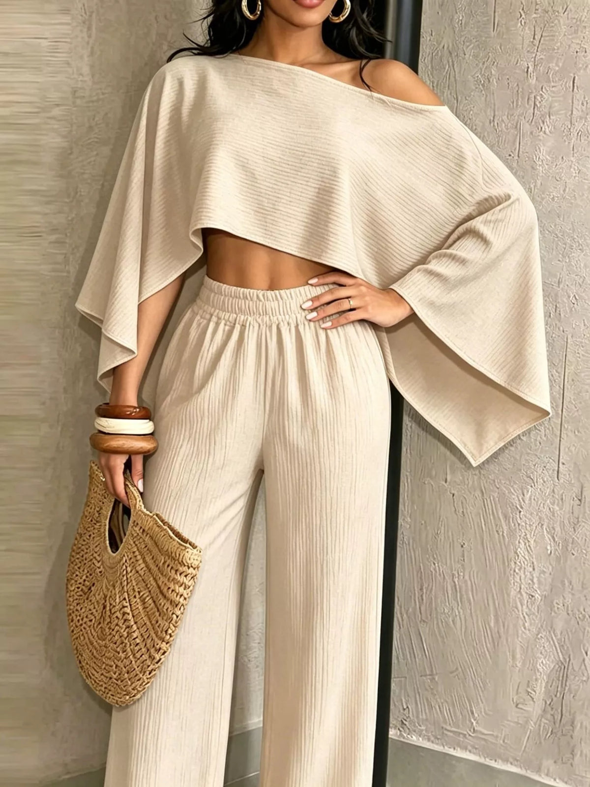 Cream wide-leg pants set with boat-neck crop top and loose flutter sleeves.