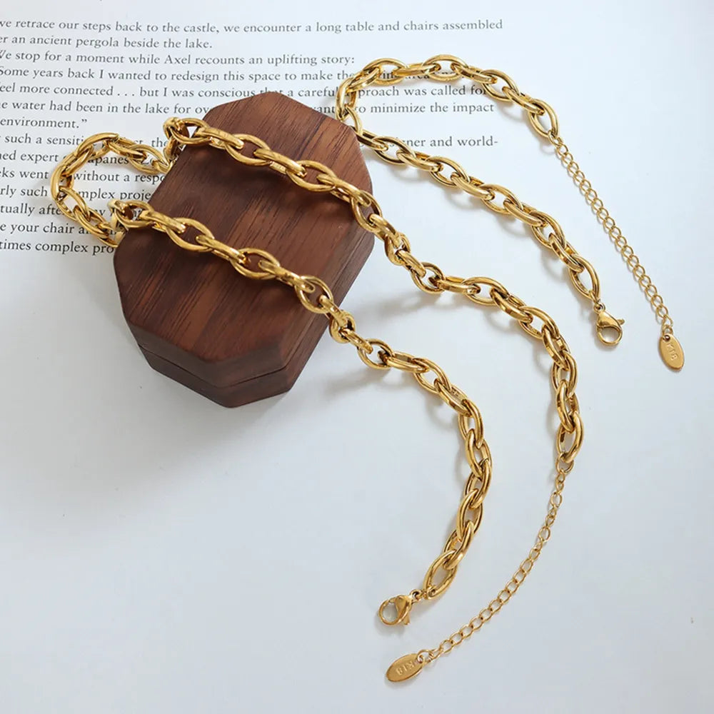 Gold chain bracelet with oval links and clasp, adjustable length.