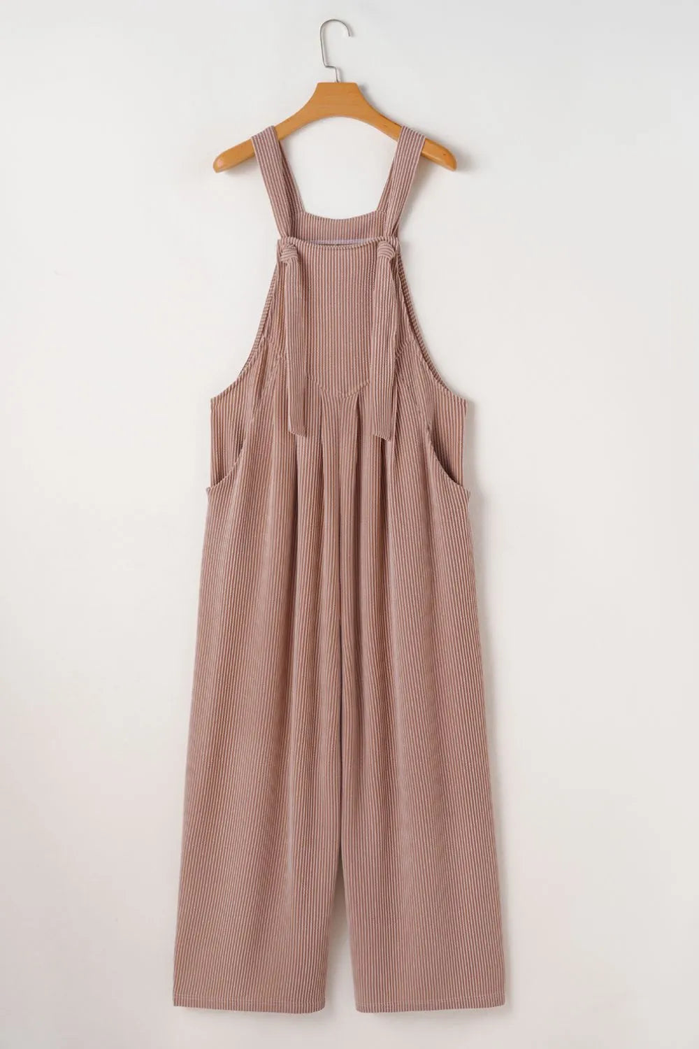 Dusty mauve wide-leg overalls on a hanger with adjustable straps and pleated bib