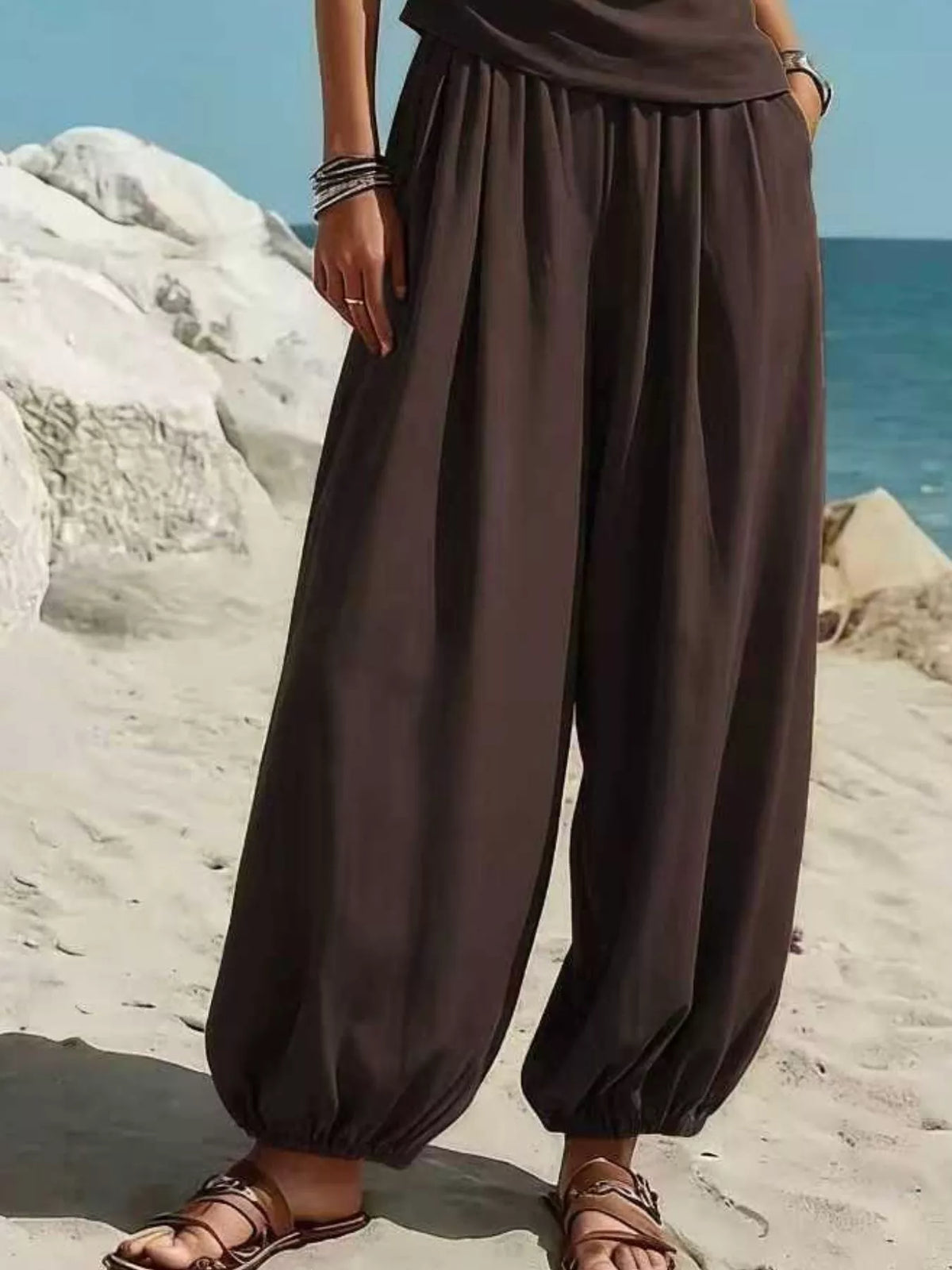 Dark brown one-shoulder sleeveless top and draped harem pants