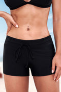 Black swim bottoms with ruched drawstring waist, side slit and tie detail