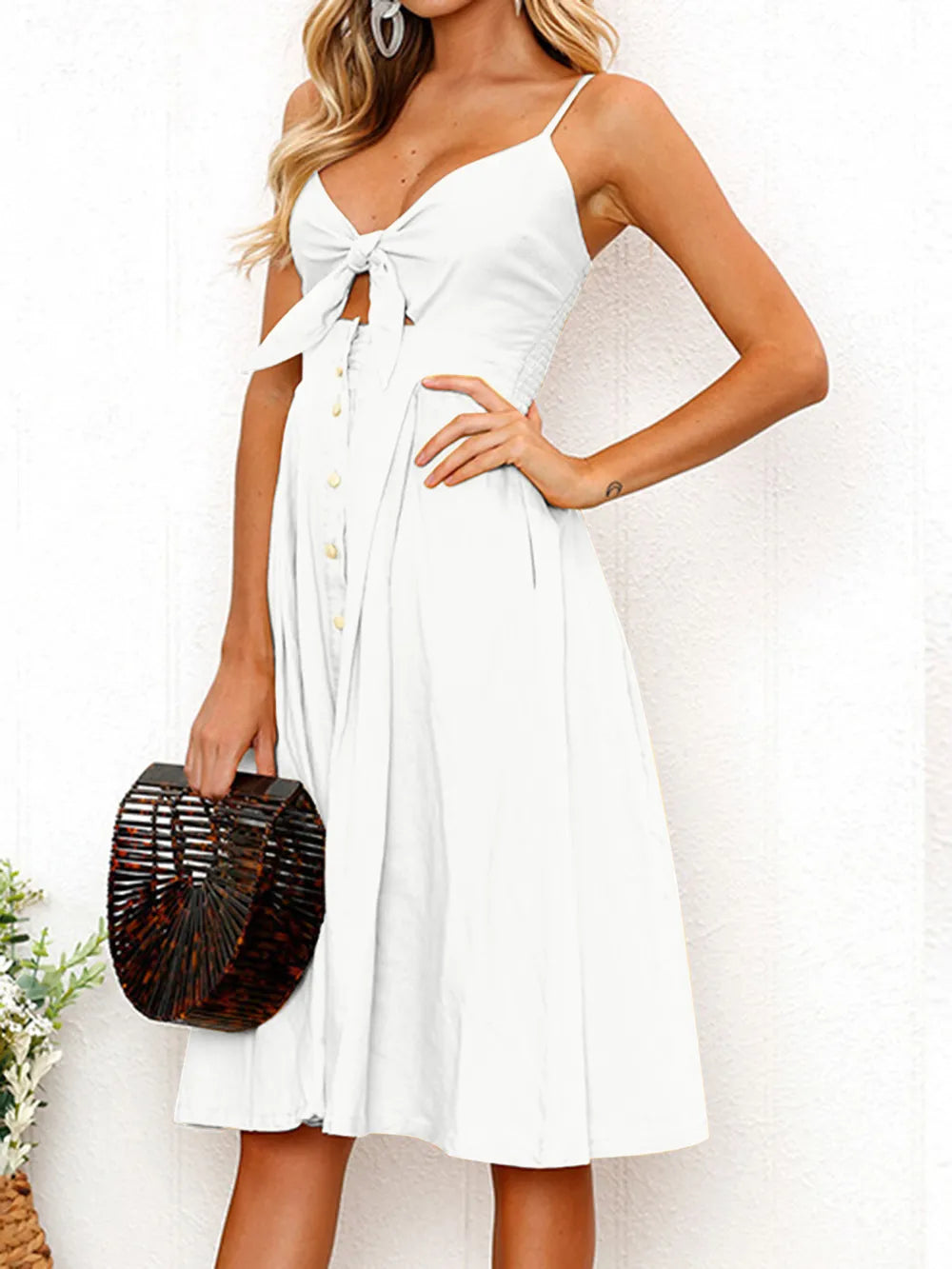 White cami dress with bow cutout bodice, sweetheart neckline, button front, flared skirt