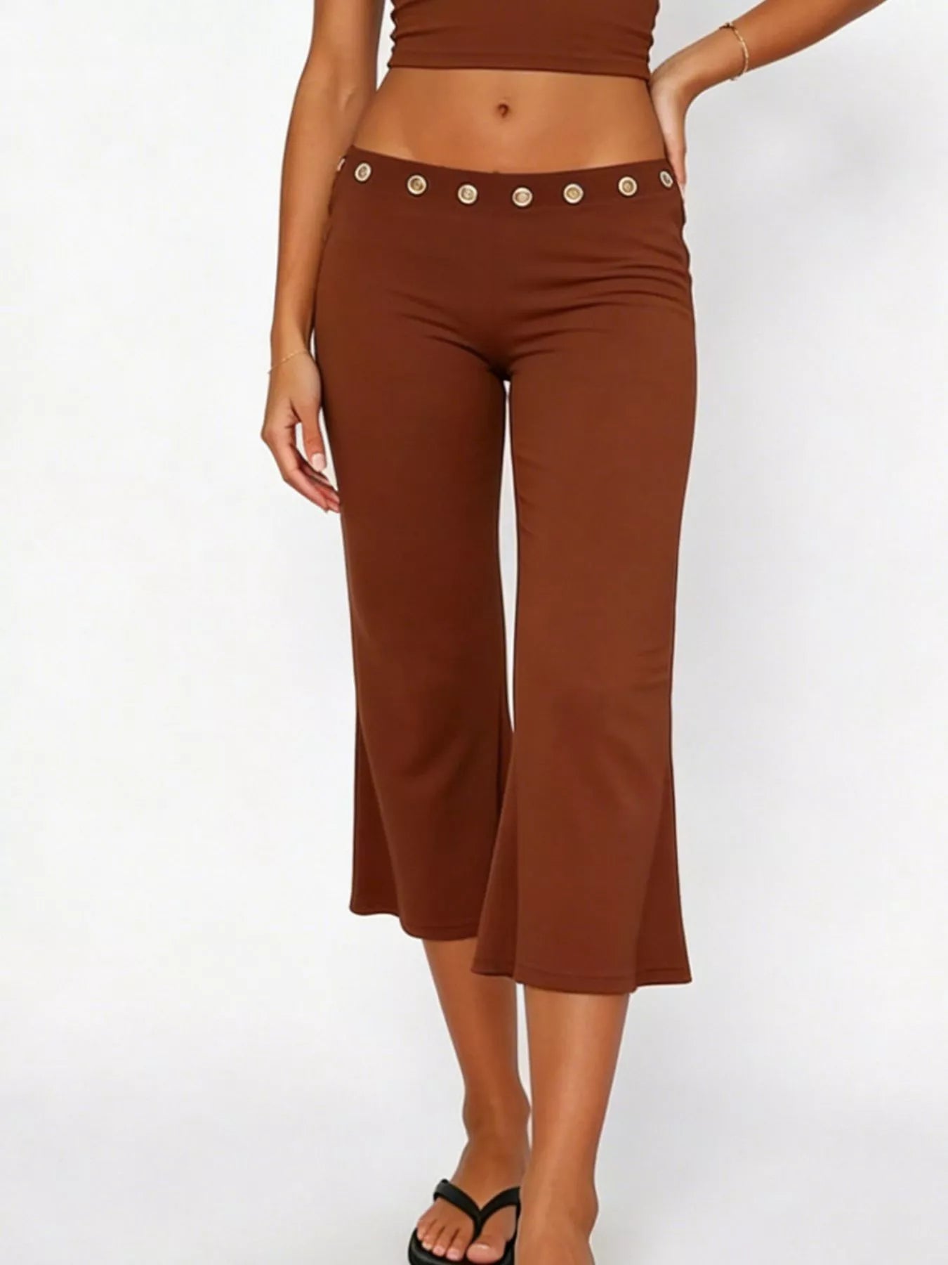Mid-rise capri pants in dark brown with silver grommet waist belt