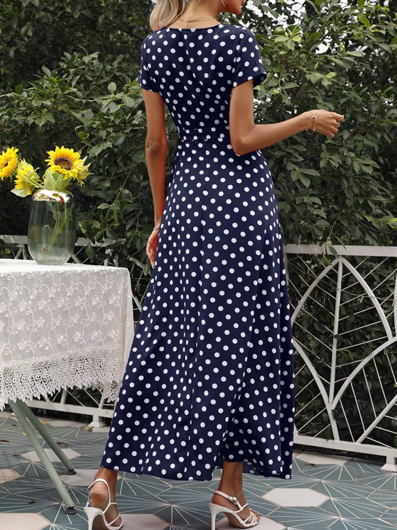 Navy polka-dot wrap maxi dress with tie belt, short sleeves, flowing skirt