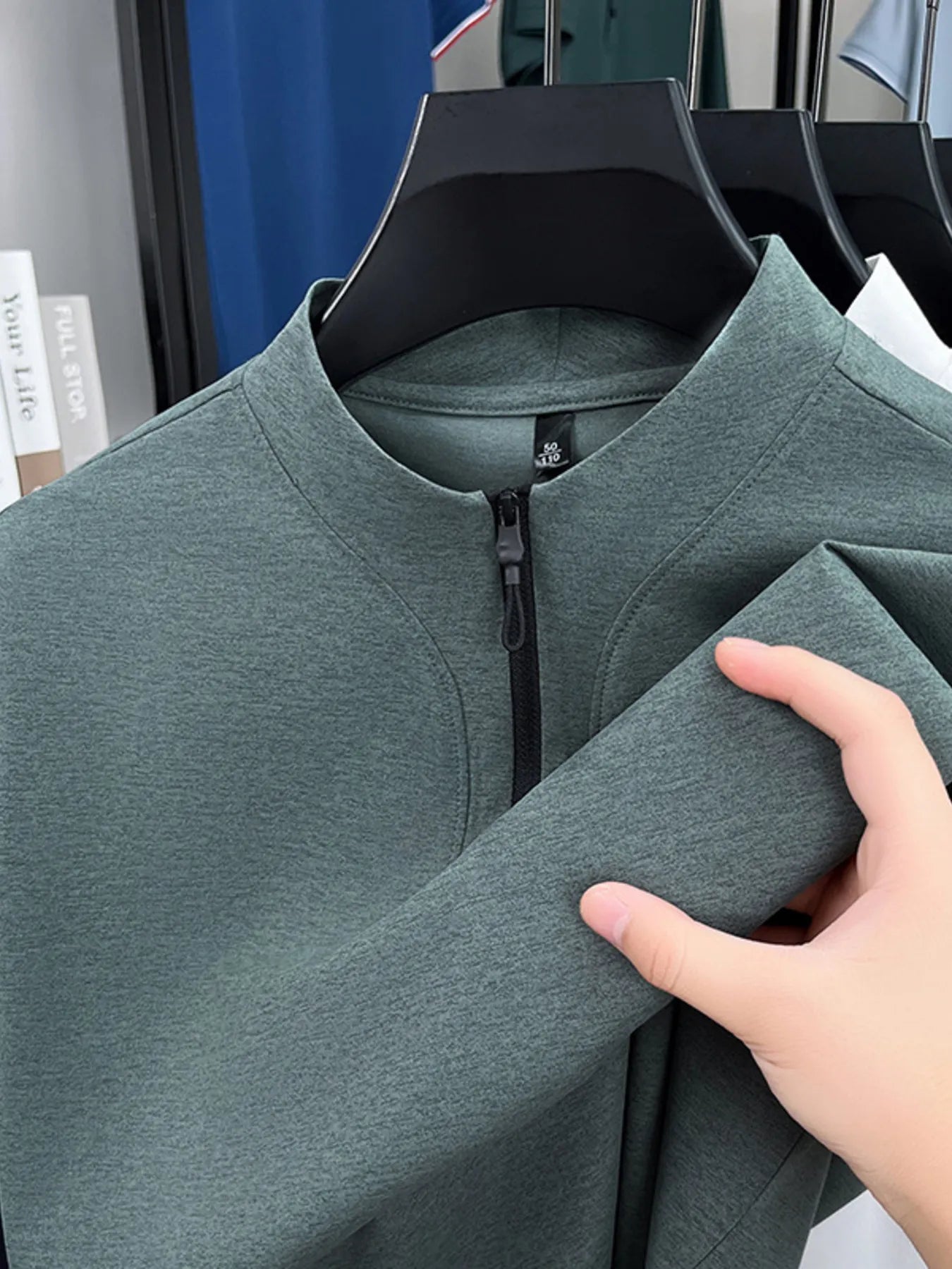 Men's quarter-zip short-sleeve top, heather green, zip placket and collar close-up
