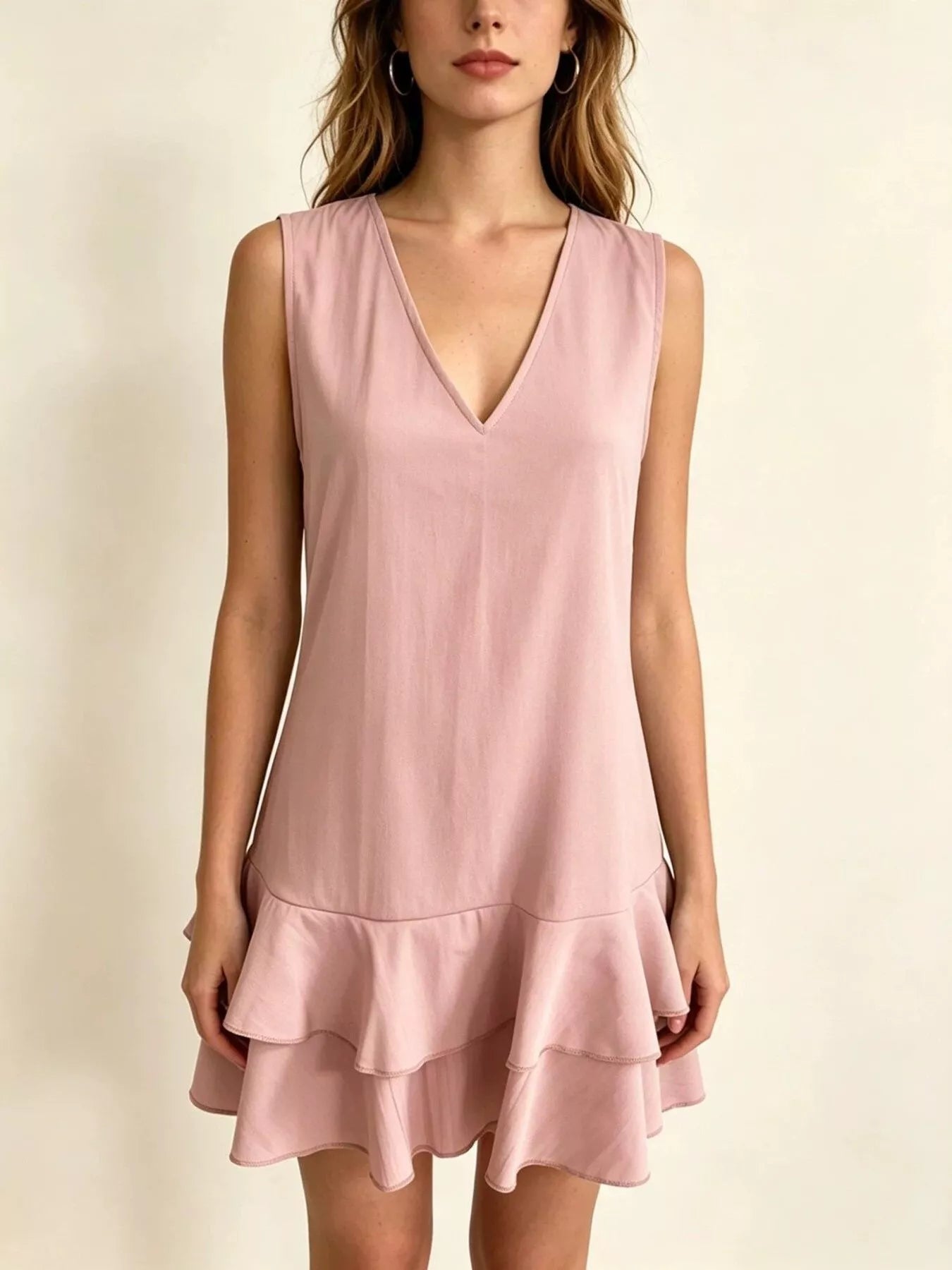 Light pink sleeveless V-neck tiered ruffle mini dress, front view