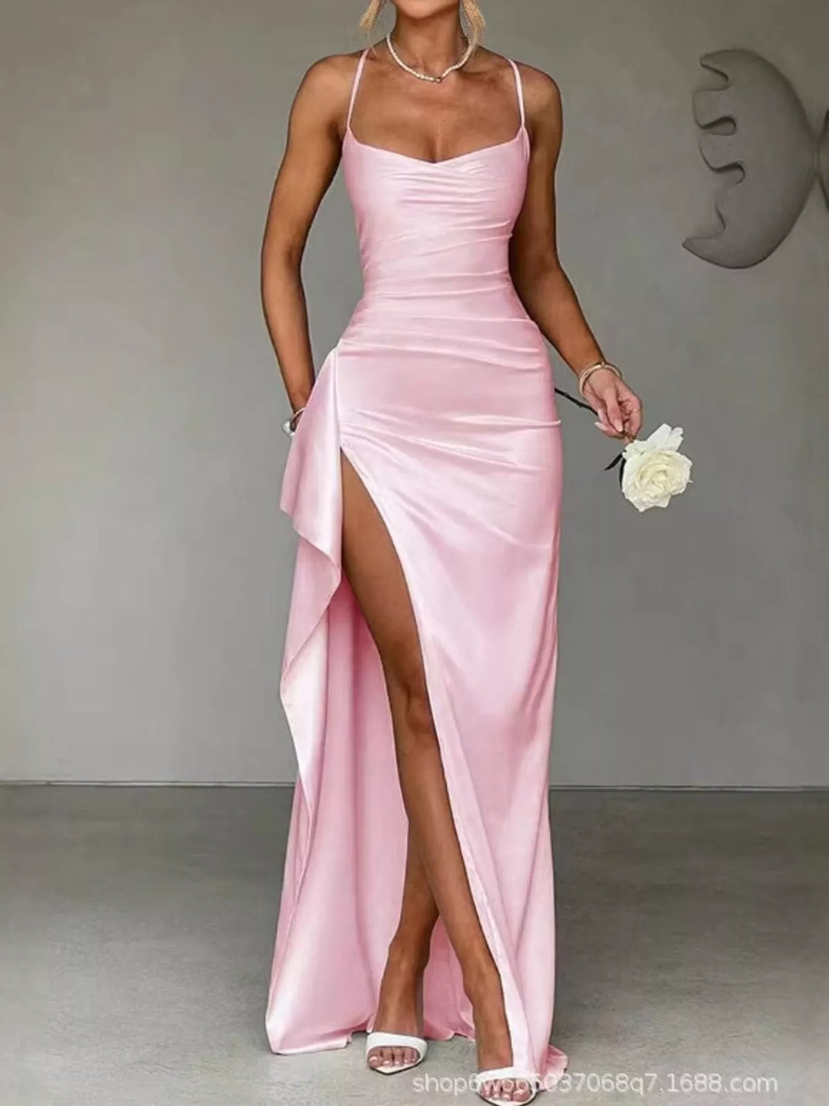 Pink satin ruched maxi dress with spaghetti straps and high side slit, draped side panel.
